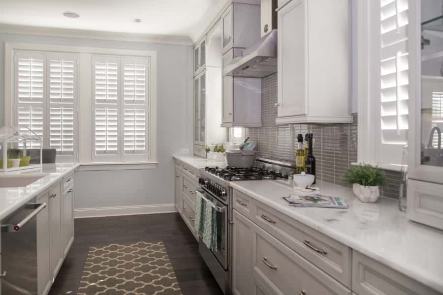 White decorative kitchen with two Polywood shutter windows.